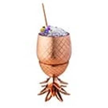 Raspberry Beret served in a pineapple cup topped with crushed ice and a flower on a skewer on white background
