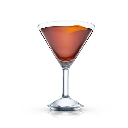 Fernet served in a martini glass with an orange twist on white background