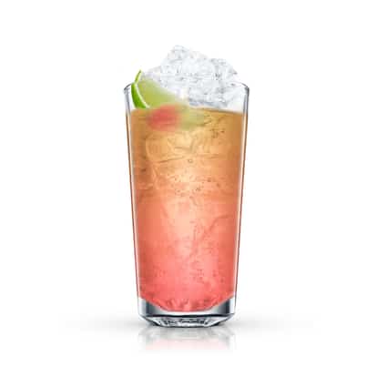 Floradora in a highball glass with crushed ice and a lime wedge on white background