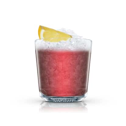 Frozen Blackberry Tequila in an Absolut rocks glass with crushed ice and a lemon wedge on white background