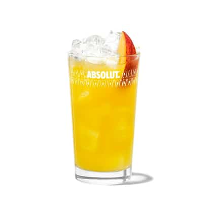 Fuzzy Navel in an Absolut highball glass with ice and a peach wedge on white background