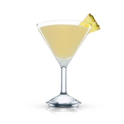 Geisha in an Absolut martini glass garnished with a pineapple wedge on white background