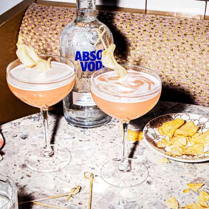 Two Ginger Cosmo cocktails served in cocktail glasses.