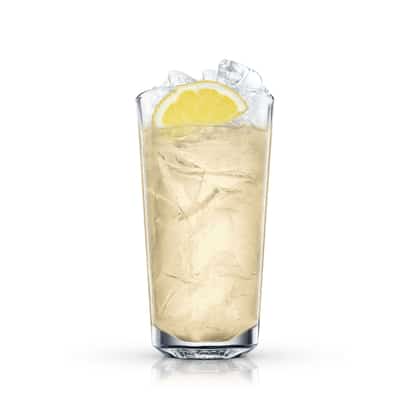Ginger-lemonade Highball in a highball glass with crushed ice and a lemon wedge on white background