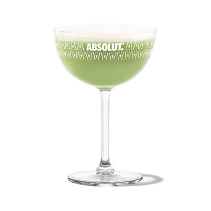 Grasshopper in an Absolut coupe glass on white background