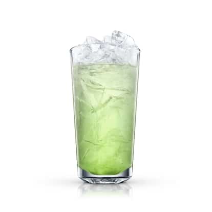 Green cocktail in a highball glass with crushed ice on white background.