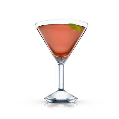 Haitian Rum Punch in a martini glass with a lime peel on white background