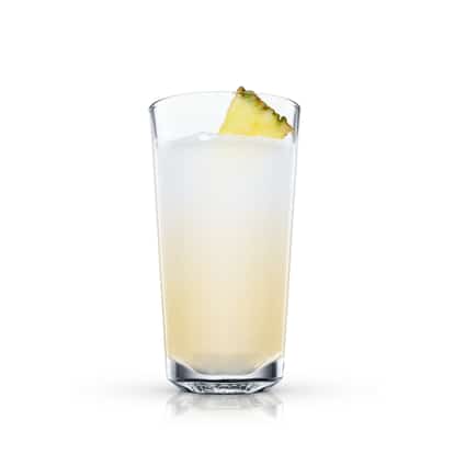 Hawaii Fizz in a highball glass with a pineapple wedge on white background