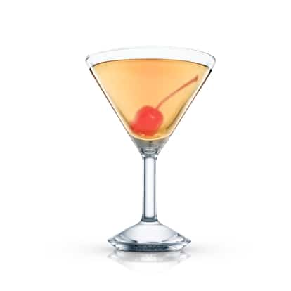 Honolule served in a martini glass with a maraschino cherry on white background.