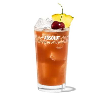 Hurricane in an Absolut highball glass with ice, pineapple wedge and cherry on white background