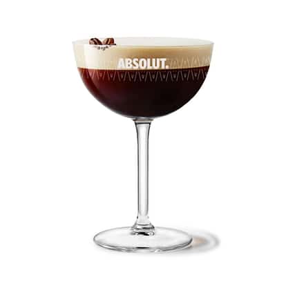 Irish Espresso-tini in an Absolut coupe glass with coffee bean garnish on white background.