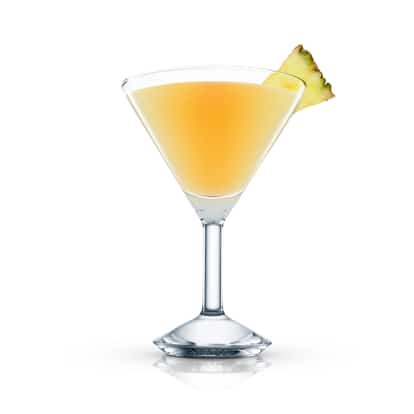 Jack Pine served in a martini glass with a pineapple wedge on the rim on white background