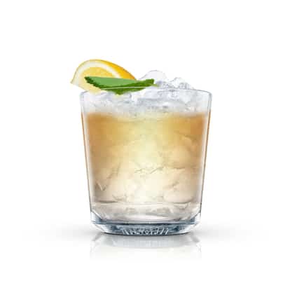 Just Add Ginger Ale in an Absolut rocks glass with crushed ice, lemon wedge and mint leaf on white background