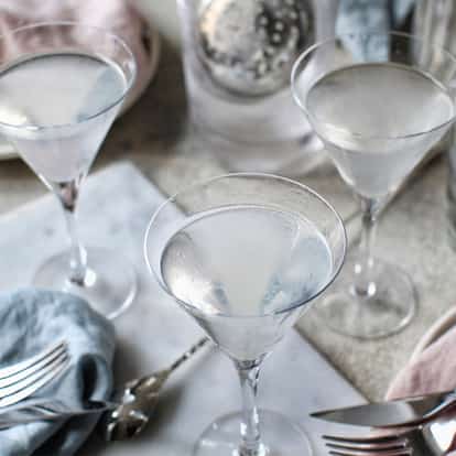 Kangaroo in three martini glasses on a table with an Absolut vodka bottle