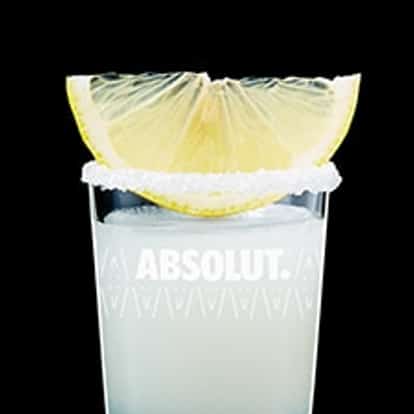 Lemon Drop Shot made with Absolut Citron Vodka, garnished with a sugar-coated rim and lemon wedge