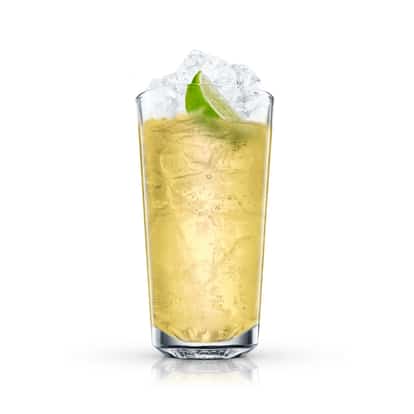 Lemonade Cooler in a highball glass with crushed ice and a lime wedge on white background