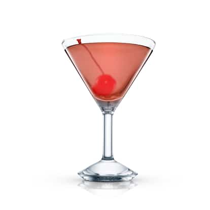 Let’s Kiss cocktail in a martini glass with a maraschino cherry on white background.