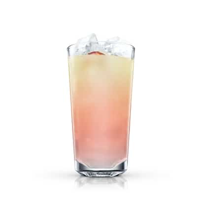 Loaf served in a highball glass with ice and a citrus wedge on white background