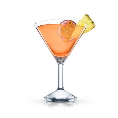 Luscious Laura in a martini glass with passionfruit half and pineapple wedge on white background