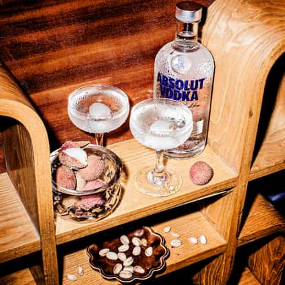 Lychee Martini next to a bottle of Absolut Vodka.