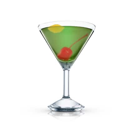Magnificent in a martini glass with a cherry and a lemon twist on white background