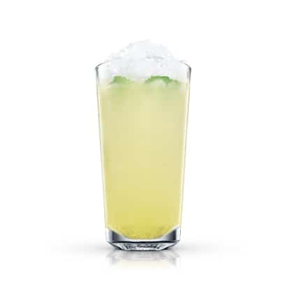 Cold pale yellow cocktail topped with crushed ice and mint, in a highball glass on white background.