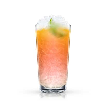 Malibu Sea Breeze in a highball glass with crushed ice and a lime wedge on white background