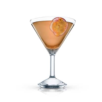 Mc Martini in a martini glass garnished with a passion fruit slice on white background