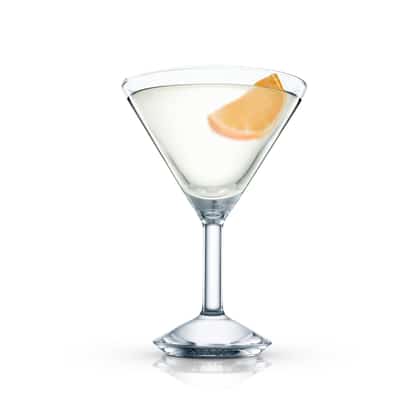 Clear cocktail in a martini glass garnished with an orange wedge on white background.