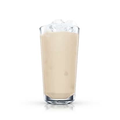 Milk Punch in a highball glass with ice on white background