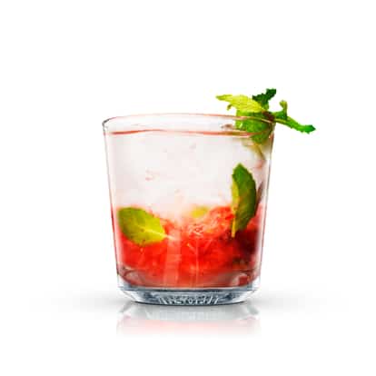 Mojito Raspberry in an Absolut rocks glass with crushed raspberries and a mint sprig on white background