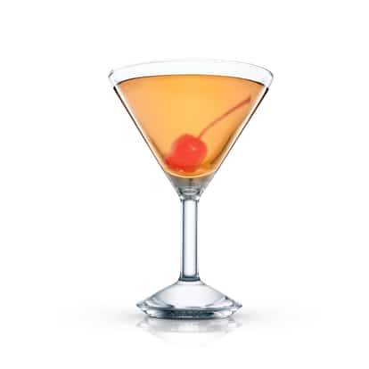 Amber cocktail in a martini glass garnished with a maraschino cherry on white background.