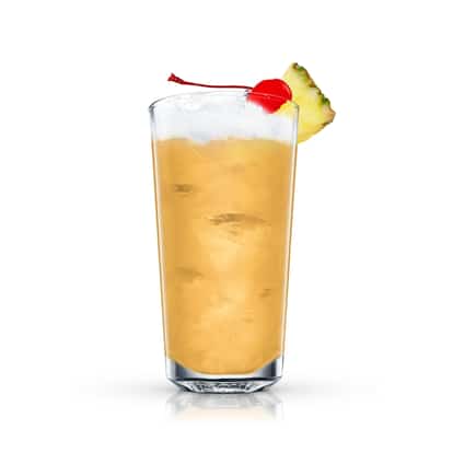 Painkiller in a highball glass with ice, pineapple wedge and cherry on white background