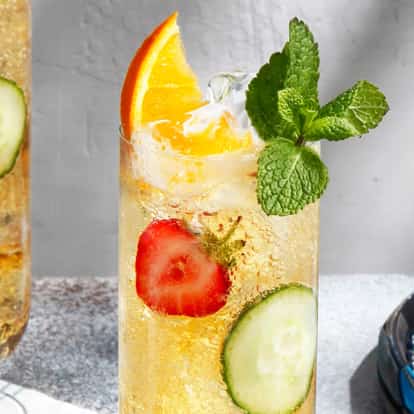 Two classic Pimm's Cup cocktails with lots of fresh garnishes.