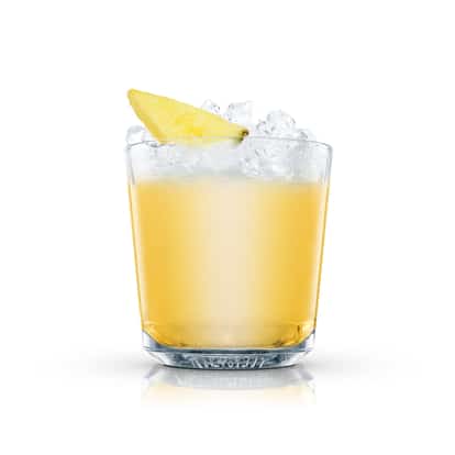 Pineapple Cobbler in an Absolut rocks glass with crushed ice and a pineapple wedge on white background