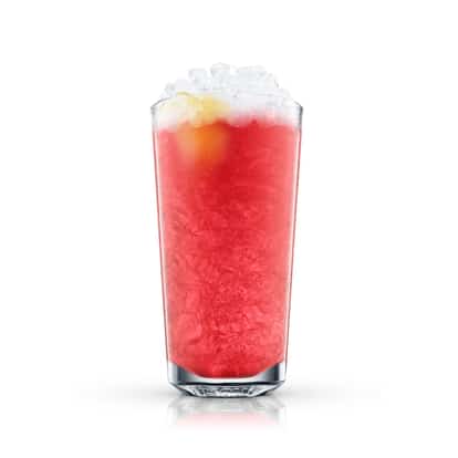 Pomegranate Fizz in a highball glass with crushed ice and a citrus garnish on white background