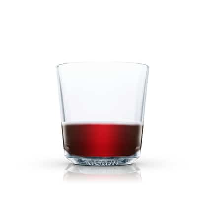 Port Flip in an Absolut rocks glass with liquid and reflection on white background