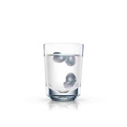 Purple Power is in a clear rocks glass with three blueberries in clear liquid on white background.