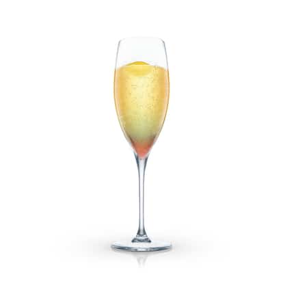 Ritz Fizz served in a champagne flute with lemon twist on white background