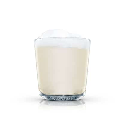 Rum Egg-nog in an Absolut rocks glass with foam on white background.