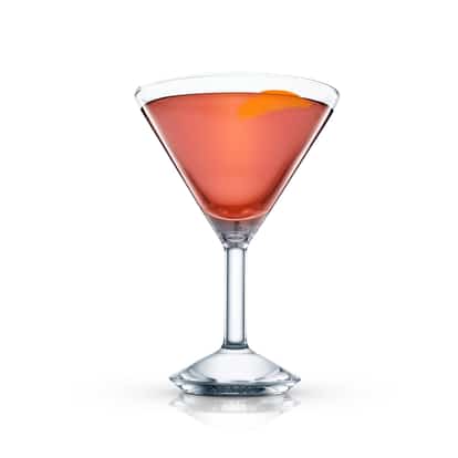 Santa Claus in a martini glass with an orange peel on white background