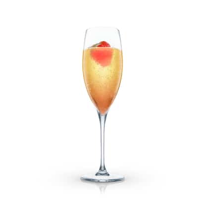 Saratoga in a champagne flute topped with a strawberry half on white background