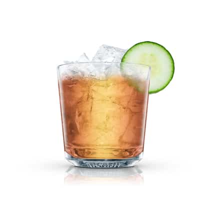 A cocktail served over ice in an Absolut rocks glass with a cucumber slice on white background.