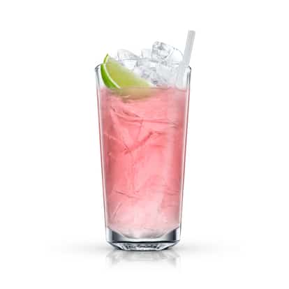Sizzling Peach served in a highball glass with crushed ice and a lime wedge on white background.