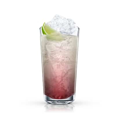 Sloe Gin Rickey in a highball glass with ice and a lime wedge on white background