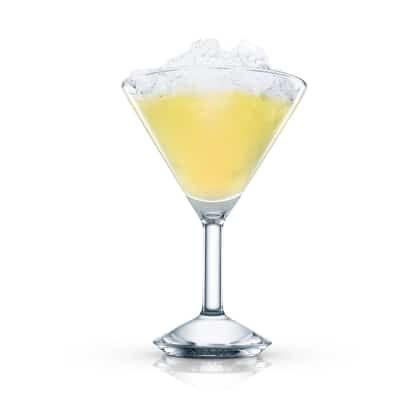 Snowball served in a martini glass topped with crushed ice and pale yellow drink on white background.