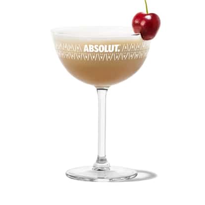 South of The Border in an Absolut coupe glass with foam and a cherry garnish