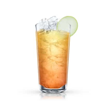 Spiced Rum Punch in a highball glass with ice and an apple slice garnish
