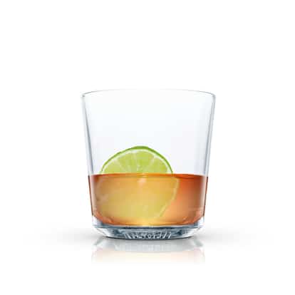 Spiced Swizzle in an Absolut rocks glass with a lime wheel on white background
