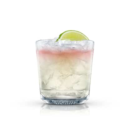 Spicy Mule in an Absolut rocks glass with crushed ice and lime wedge on white background.